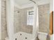 Bathroom featuring bathtub, shower, and tiled walls at 5015 Carrollton Ave, Indianapolis, IN 46205