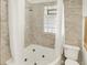 Bathroom featuring an elegant bathtub, and tiled walls at 5015 Carrollton Ave, Indianapolis, IN 46205