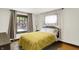 Cozy bedroom with natural light, hardwood floors, and neutral-colored walls at 5015 Carrollton Ave, Indianapolis, IN 46205