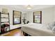 Inviting bedroom with hardwood floors, neutral walls, and natural light at 5015 Carrollton Ave, Indianapolis, IN 46205