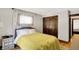 Charming bedroom featuring hardwood floors, closet, and large windows at 5015 Carrollton Ave, Indianapolis, IN 46205