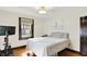 Well-lit bedroom featuring hardwood floors and a cozy window at 5015 Carrollton Ave, Indianapolis, IN 46205