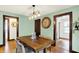 Inviting dining room featuring a wood table, stylish lighting, and neutral decor at 5015 Carrollton Ave, Indianapolis, IN 46205