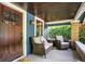 Cozy front porch featuring comfortable seating and brick accents, perfect for relaxing outdoors at 5015 Carrollton Ave, Indianapolis, IN 46205