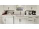 Bright kitchen featuring white cabinets, quartz countertops and stainless steel appliances at 5015 Carrollton Ave, Indianapolis, IN 46205