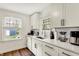 Bright kitchen with white cabinets, quartz countertops, and modern stainless steel appliances at 5015 Carrollton Ave, Indianapolis, IN 46205