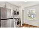 Bright kitchen with white cabinets, stainless steel appliances, and hardwood floors at 5015 Carrollton Ave, Indianapolis, IN 46205