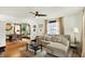 Spacious living room with hardwood floors, a sectional sofa, and an open view into the adjacent dining area at 5015 Carrollton Ave, Indianapolis, IN 46205
