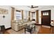 Bright living room featuring hardwood floors, neutral decor, and a comfortable sectional sofa at 5015 Carrollton Ave, Indianapolis, IN 46205