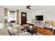 Bright living room with hardwood floors, a comfortable sectional, and a stylishly arranged entertainment area at 5015 Carrollton Ave, Indianapolis, IN 46205