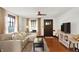 Inviting living room features a sectional sofa, hardwood floors, and a TV entertainment area at 5015 Carrollton Ave, Indianapolis, IN 46205