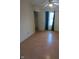 Bright bedroom featuring hardwood floors, window with curtains, and closet for ample storage at 5043 Harway Ct, Indianapolis, IN 46227