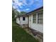 Side view of house with vinyl siding and visible gutter system under cloudy blue sky at 5043 Harway Ct, Indianapolis, IN 46227