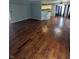 Expansive living room boasts hardwood floors, transitioning into a modern kitchen space at 5043 Harway Ct, Indianapolis, IN 46227
