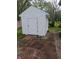 White shed exterior with vinyl siding and double-door access, set on brick pavers at 5043 Harway Ct, Indianapolis, IN 46227