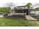 A well-maintained backyard featuring a charming swing set, manicured lawn, and hot tub for relaxation at 5137 Green Hills Dr, Brownsburg, IN 46112