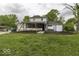 Spacious backyard with a swing set, enclosed porch, and garage at 5137 Green Hills Dr, Brownsburg, IN 46112