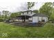 Expansive backyard featuring a screened-in porch, hot tub, and swing set, perfect for outdoor enjoyment at 5137 Green Hills Dr, Brownsburg, IN 46112