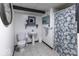 Simple bathroom featuring pedestal sink, toilet, and a floral shower curtain at 5137 Green Hills Dr, Brownsburg, IN 46112