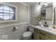 Bathroom with shiplap walls, wooden vanity, and unique glass block window at 5137 Green Hills Dr, Brownsburg, IN 46112