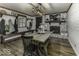 Dining area with brick fireplace, white shiplap, wooden floors, and country style furniture at 5137 Green Hills Dr, Brownsburg, IN 46112