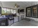 Cozy enclosed porch with brick walls, ceiling fan, and comfortable seating area at 5137 Green Hills Dr, Brownsburg, IN 46112