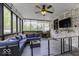 Relaxing enclosed porch with brick walls, ceiling fan, and comfortable sectional sofa at 5137 Green Hills Dr, Brownsburg, IN 46112