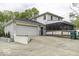 This home features an extended driveway, brick accents, attached garage, and enclosed porch at 5137 Green Hills Dr, Brownsburg, IN 46112