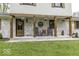 Inviting front porch with rocking chairs, rustic decor, and hanging flower baskets for a charming welcome at 5137 Green Hills Dr, Brownsburg, IN 46112