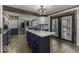 Bright kitchen featuring wooden beams, white cabinets, a marble countertop island, and modern stainless steel appliances at 5137 Green Hills Dr, Brownsburg, IN 46112