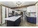 Bright kitchen featuring wooden beams, white cabinets, a marble countertop island, and modern stainless steel appliances at 5137 Green Hills Dr, Brownsburg, IN 46112
