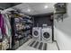 A laundry room with front load washer and dryer and overhead rack shelving at 5137 Green Hills Dr, Brownsburg, IN 46112