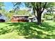 Backyard featuring mature trees, lawn, and deck for outdoor enjoyment at 5225 Elderberry Rd, Noblesville, IN 46062