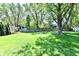 Large, grassy backyard with mature trees and a wooden fence at 5225 Elderberry Rd, Noblesville, IN 46062