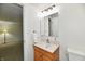 A simple bathroom with a light wood vanity, a medicine cabinet mirror, and neutral walls creates a clean aesthetic at 5225 Elderberry Rd, Noblesville, IN 46062