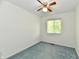 Cozy carpeted bedroom with a ceiling fan and window, providing a comfortable and well-lit space at 5225 Elderberry Rd, Noblesville, IN 46062