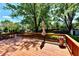 Spacious wooden deck with railing, an umbrella, a flower pot, and a beautiful view of the backyard at 5225 Elderberry Rd, Noblesville, IN 46062