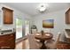 Staged dining area with a round table, four chairs, wood floors, and sliding glass doors at 5225 Elderberry Rd, Noblesville, IN 46062