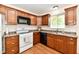 Well-maintained kitchen features wooden cabinets, laminate countertops, and modern appliances at 5225 Elderberry Rd, Noblesville, IN 46062