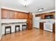 Spacious kitchen with wooden floors, wooden cabinets, breakfast bar, and modern appliances at 5225 Elderberry Rd, Noblesville, IN 46062