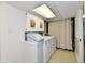 Laundry room with large capacity washer and dryer, plus extra storage cabinets above provides convenience at 5225 Elderberry Rd, Noblesville, IN 46062