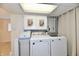 Laundry room with large capacity washer and dryer, plus extra storage cabinets above is efficient and practical at 5225 Elderberry Rd, Noblesville, IN 46062
