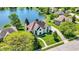 Stunning aerial of a lakeside home with mature trees and a manicured lawn at 5521 Salem N Dr, Carmel, IN 46033