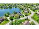 Aerial view of a community with large pond and well-manicured lawns at 5521 Salem N Dr, Carmel, IN 46033