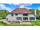 Stunning back exterior with a spacious deck, large windows, and lush lawn, perfect for entertaining at 5521 Salem N Dr, Carmel, IN 46033