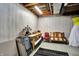 Basement area with paneled walls, exposed ceiling, seating arrangement, and folding tables at 5521 Salem N Dr, Carmel, IN 46033