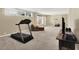 Spacious finished basement with workout equipment, neutral walls, and natural light at 5521 Salem N Dr, Carmel, IN 46033