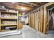 Unfinished basement with storage shelving, exposed ceiling, and concrete floors at 5521 Salem N Dr, Carmel, IN 46033