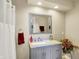 Modern bathroom with gray vanity, marble countertop, and decorative accents at 5521 Salem N Dr, Carmel, IN 46033