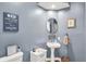 Charming half bathroom with a pedestal sink, decorative accents, and painted walls at 5521 Salem N Dr, Carmel, IN 46033